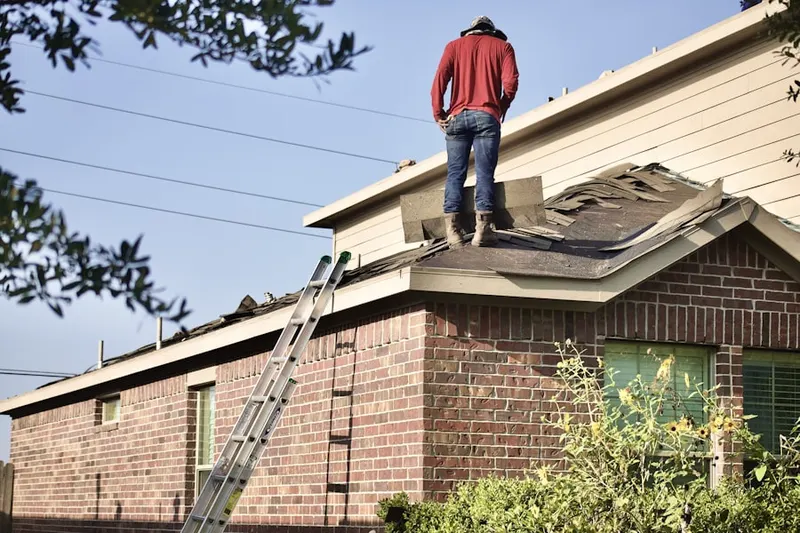 Professional roofer working on a residential roof in Copper City